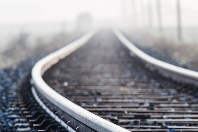 Einspurige Bahnlinie im Morgennebel