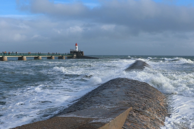 Stürmische See, im Hintergrund eine Seebrücke und ein Leuchtturm