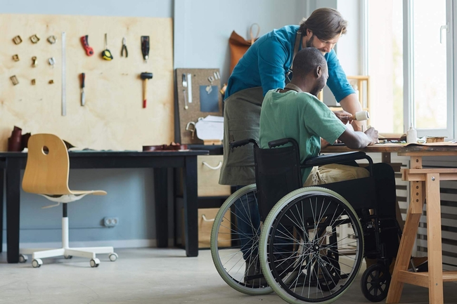 Mensch mit Behinderung arbeitet in Werkstatt