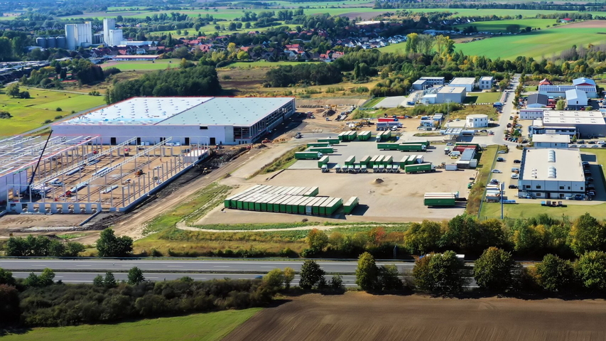 Blick von oben auf ein entstehendes Industriegebietes, in der Nähe eines Wohngebietes